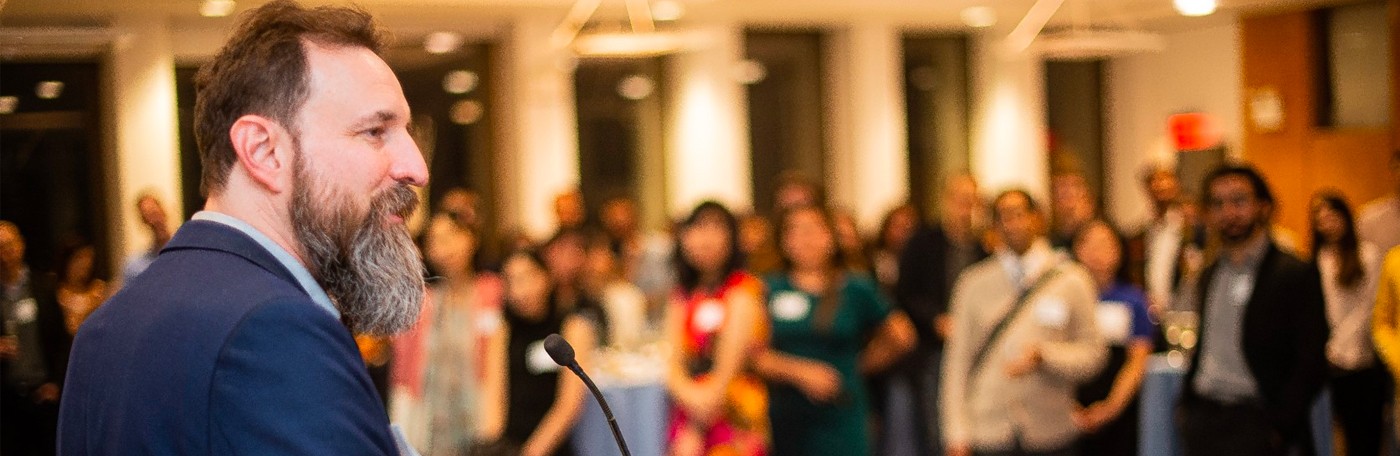Students surrounding a speaker at an event